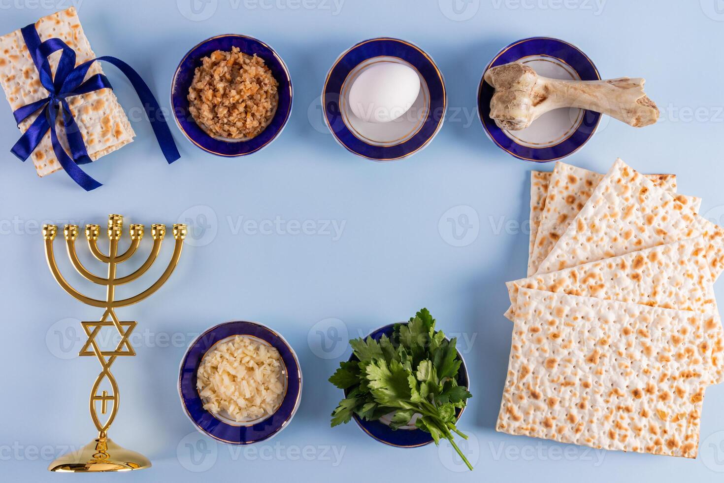 Traditional treats for the Jewish Passover holiday, a minor candlestick, homemade matzoth. Top view. Blue background. frame. space for text. photo