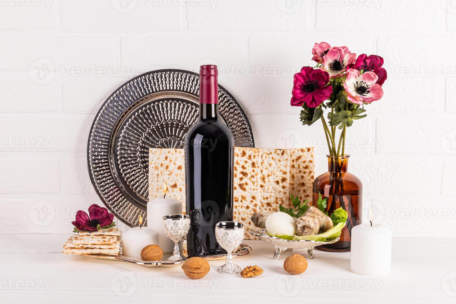 Beautiful still life for the spring holiday of Jewish Passover. Front view of traditional products for holiday, matzoth, bottle of red wine, dish photo