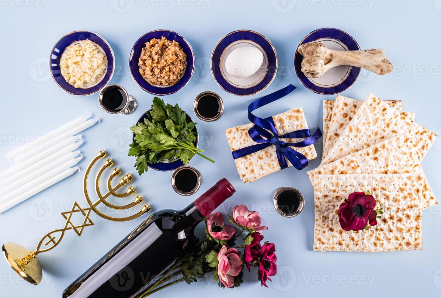 Beautiful festive background for the holiday of Jewish Passover. Traditional kosher treats and symbols on a blue background. Flat lay. Top view. photo