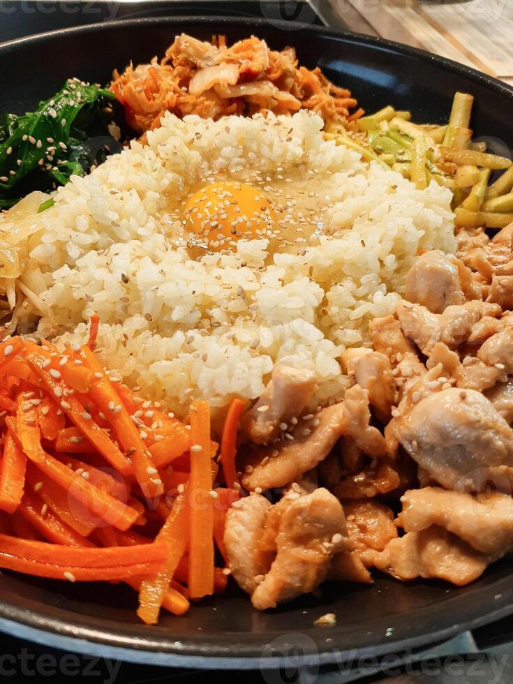 Bibimbap dish of meat, rice, vegetables and egg photo