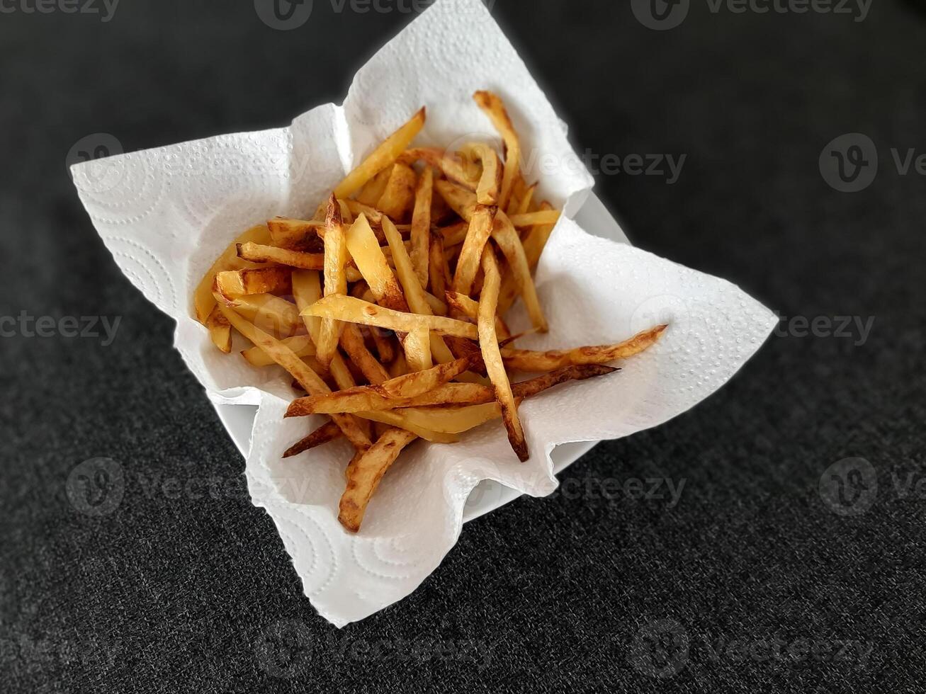 francés papas fritas en blanco papel cocina toalla foto