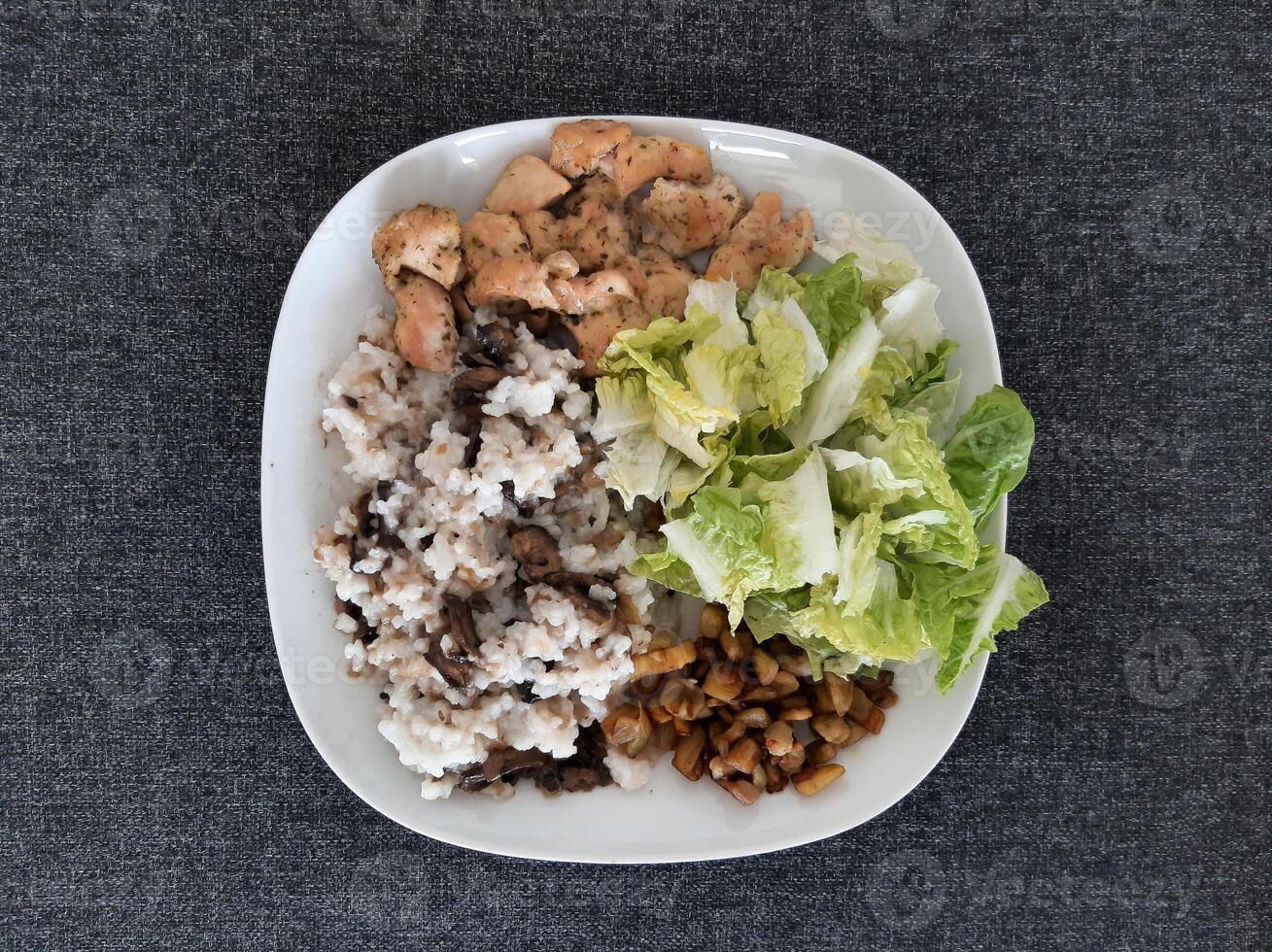 Homemade grilled chicken with grilled chopped eggplant, green salad, and rice Pilaf with mushrooms photo