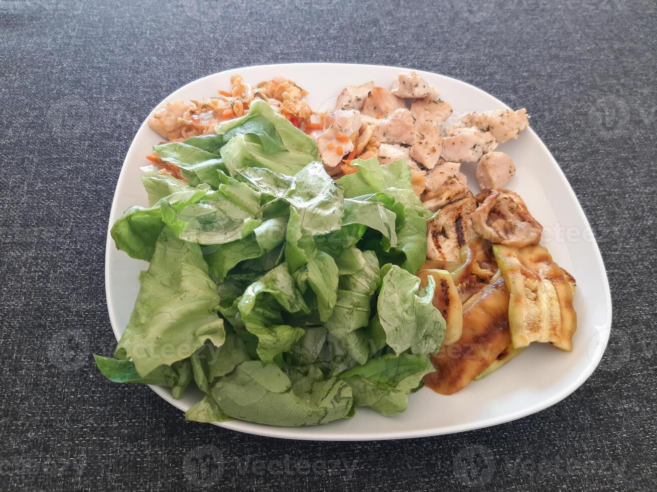 Homemade grilled chicken with grilled zucchini, green salad, avocado and Kimchi photo