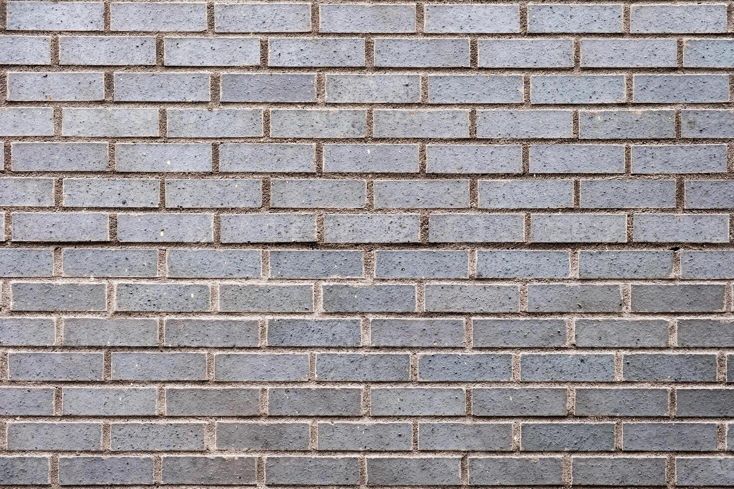 Weathered grey stained brick wall photo