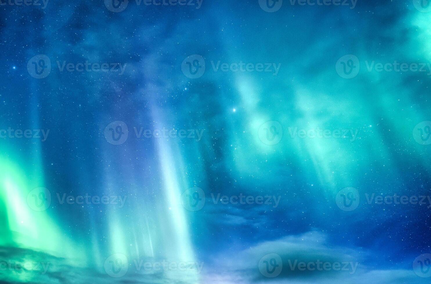 Bright and active Aurora borealis or Northern lights glowing in the night sky on Arctic circle photo