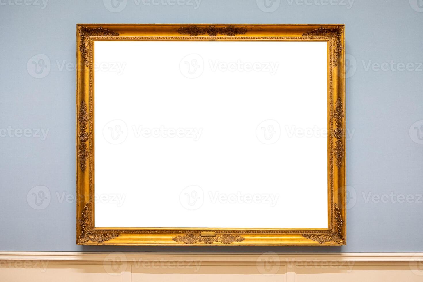 Golden carved picture frame on wall photo