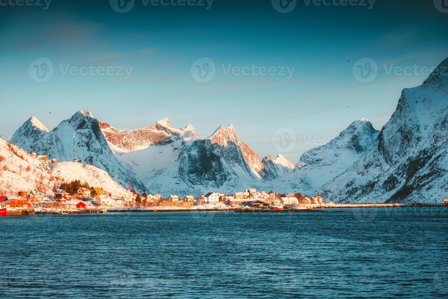 Winter wonderland of Reine town fishing village with fjord mountain in the morning at Lofoten Islands photo