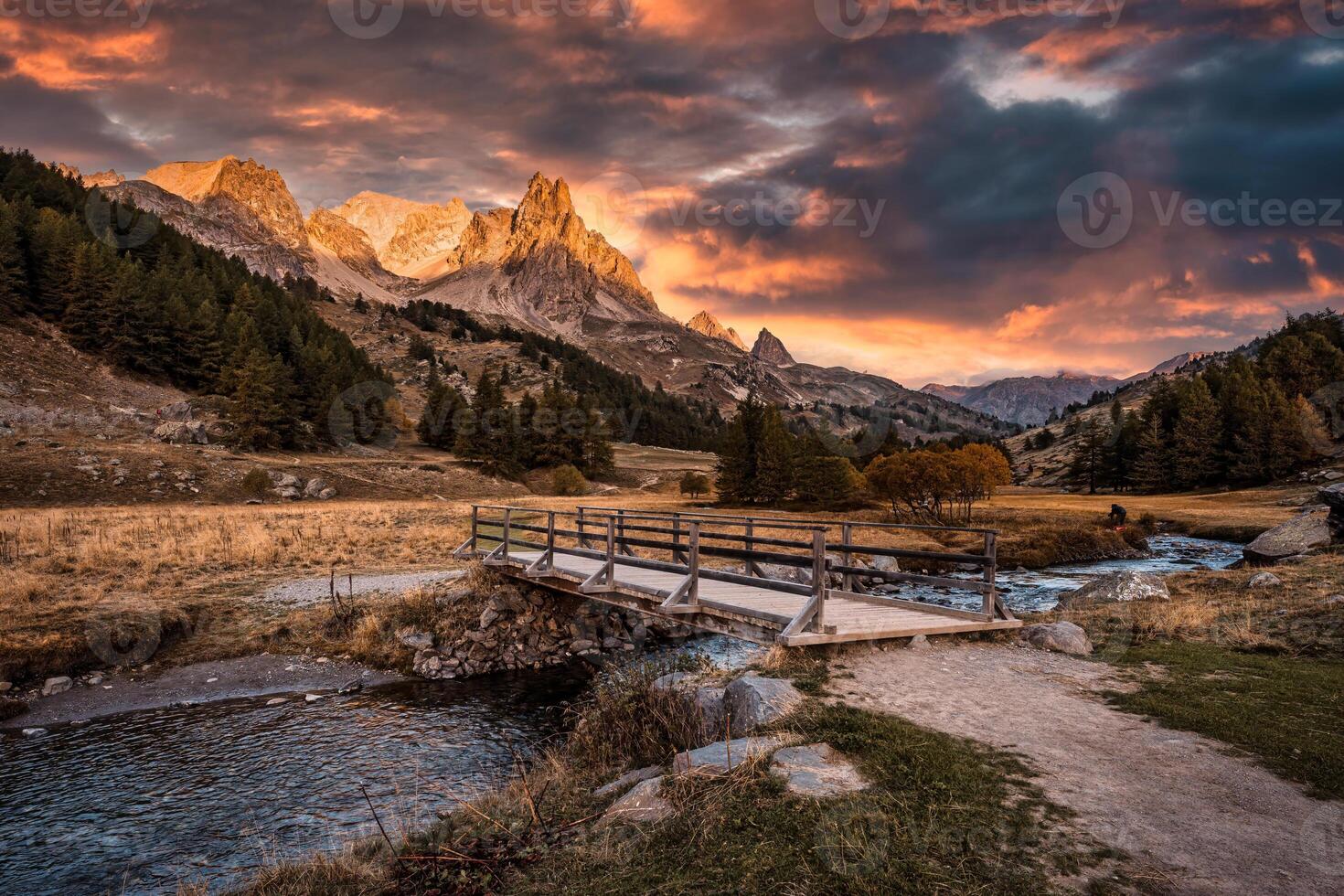 Sunset over Claree valley with Main De Crepin peak in autumn forest at French Alps, France photo