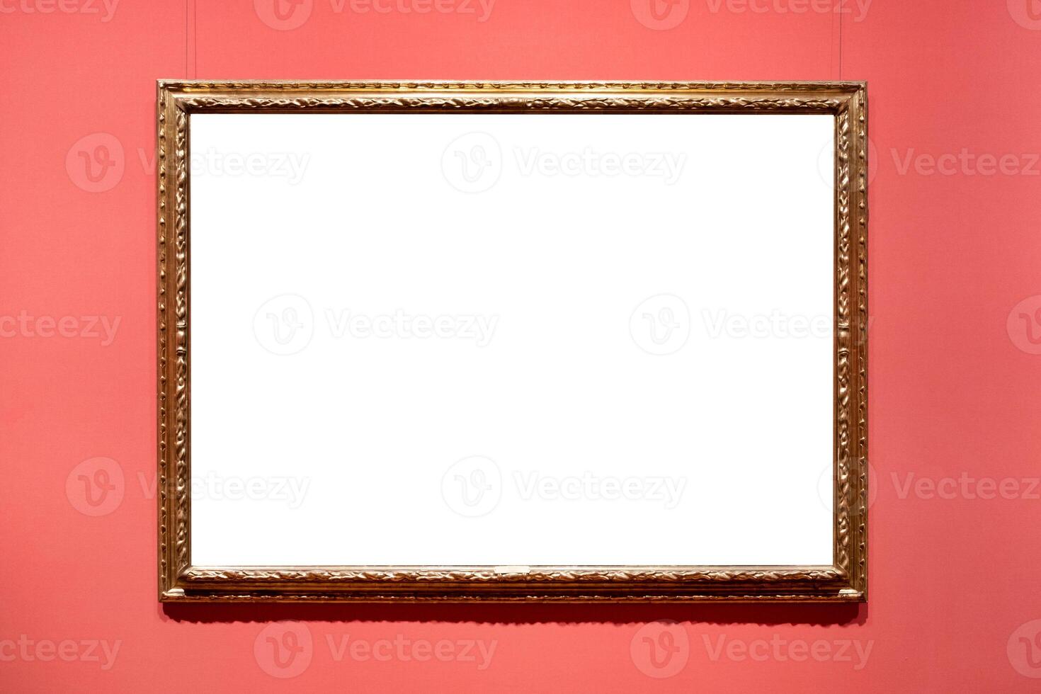 Antique golden carved picture frame on wall photo