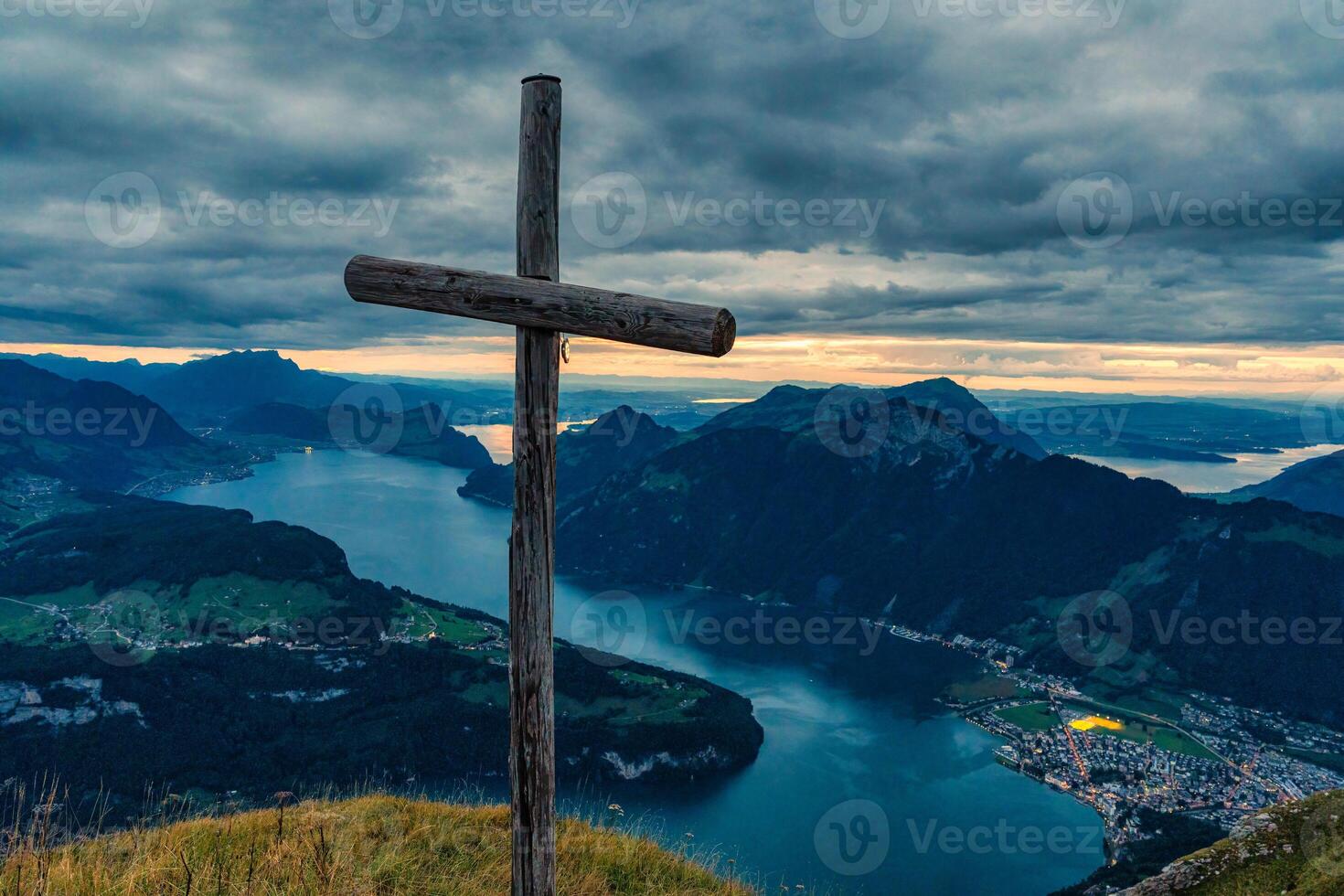 Wooden cross on summit with moody sky overlooking Lake Lucerne at Fronalpstock, Switzerland photo