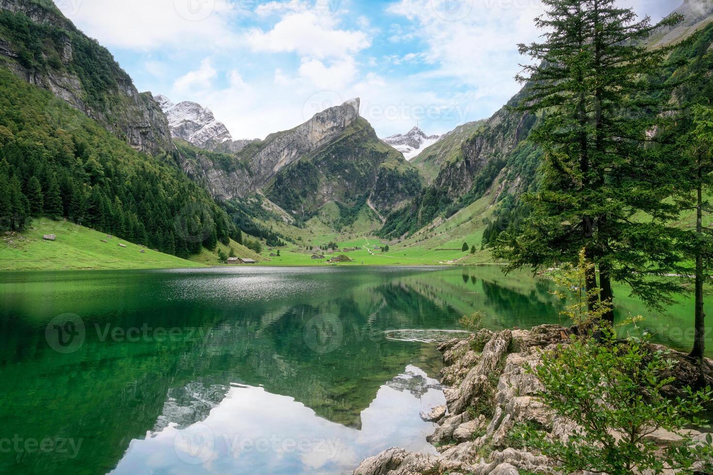 Seealpsee mountain lake reflection in Alpstein mountain range during summer at Switzerland photo