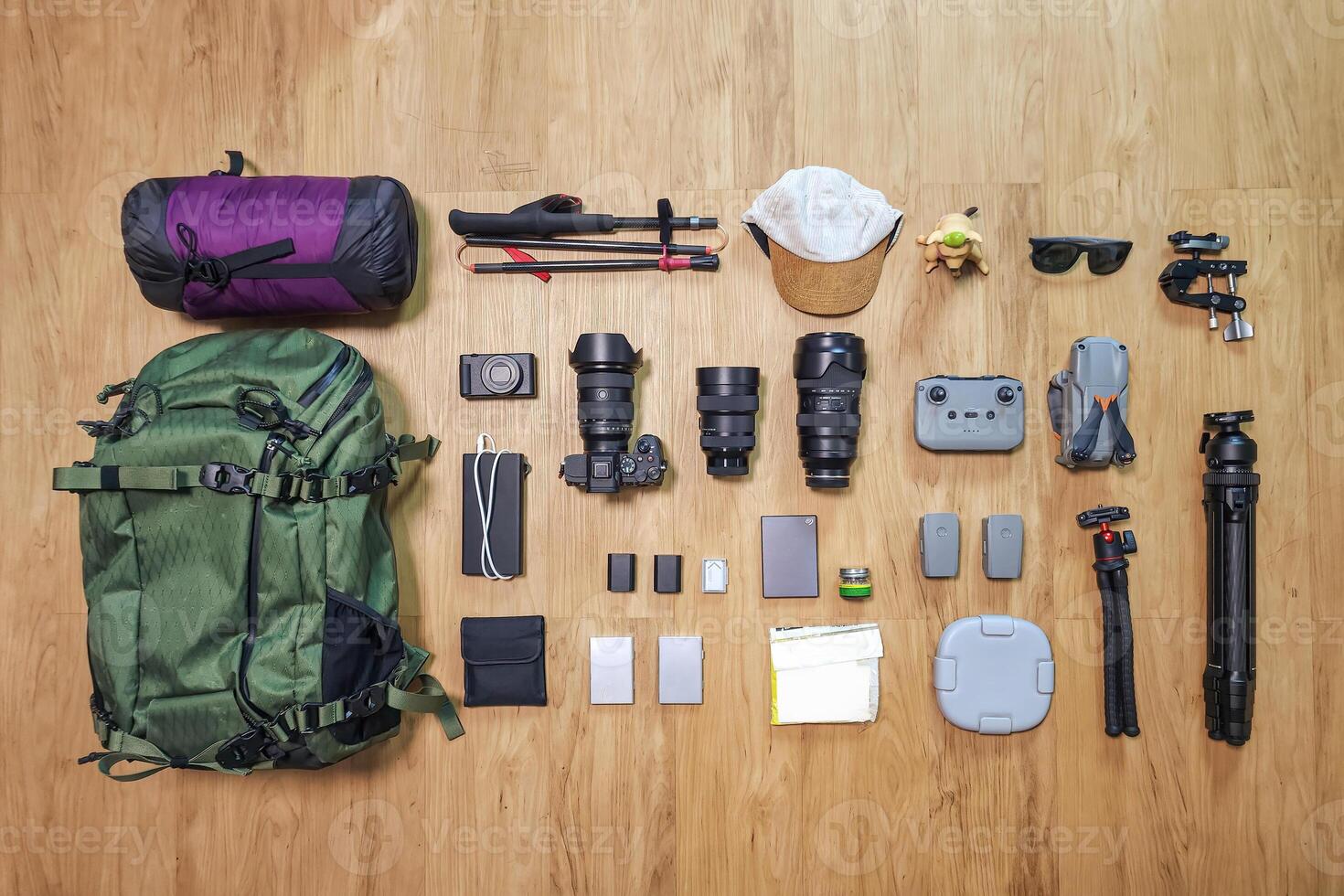 Set of photographer gear with mirrorless camera, lens, tripod, drone and backpack photo