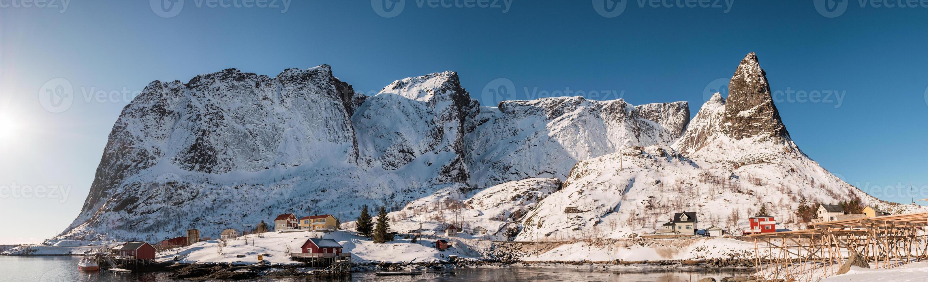 Panorama fishing village on coastline with mountain range background at Lofoten islands photo