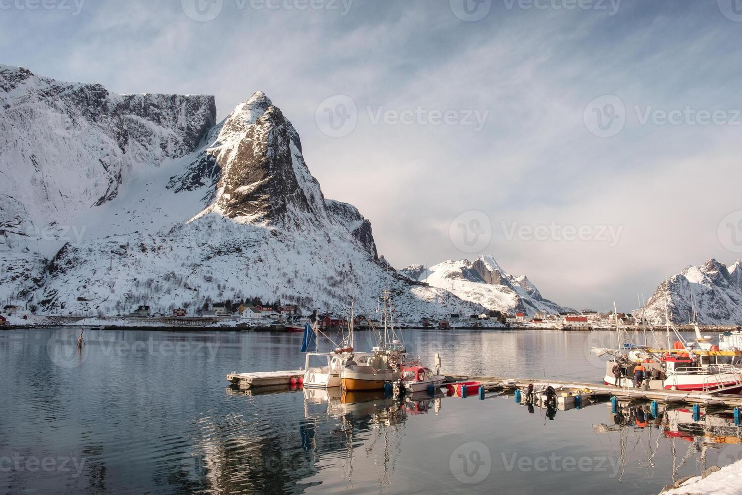 Fishing boat at harbour with snowy mountain photo