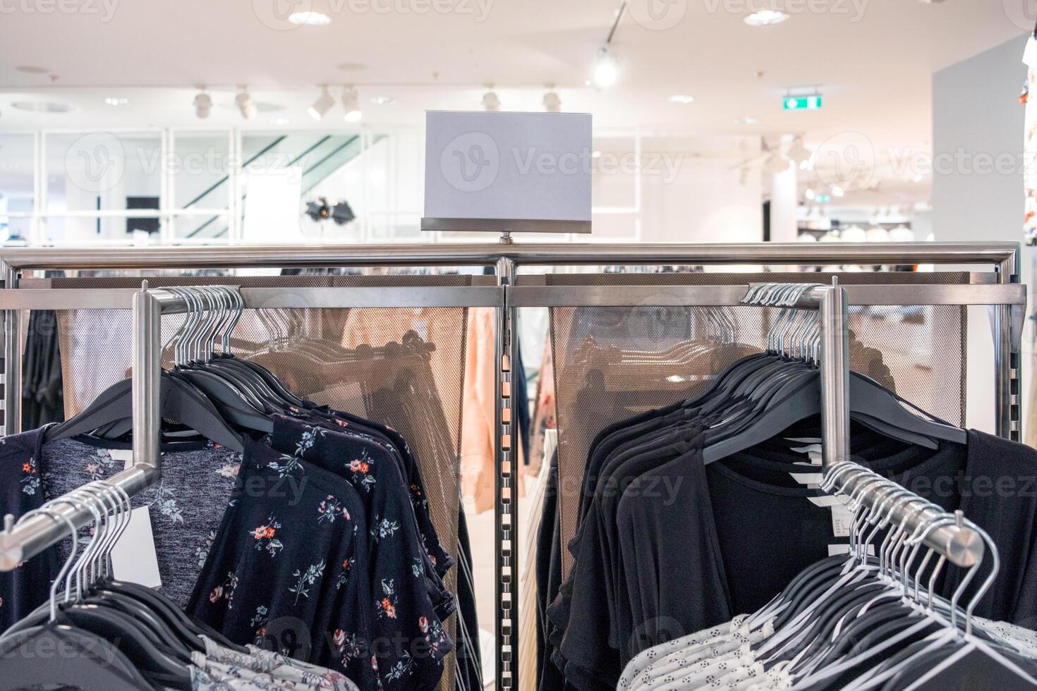 Women fashion clothes hanging on the rail with price tag photo