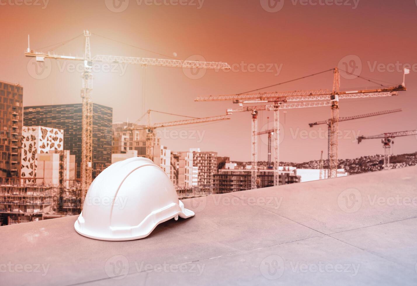 Safety hard helmet for construction engineer and worker on cranes and building background photo