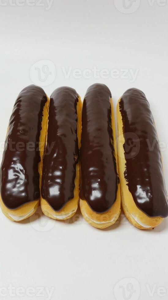 AI generated Eclairs, lineup of chocolate-glazed eclairs filled with creamy pastry cream, background image, generative AI photo