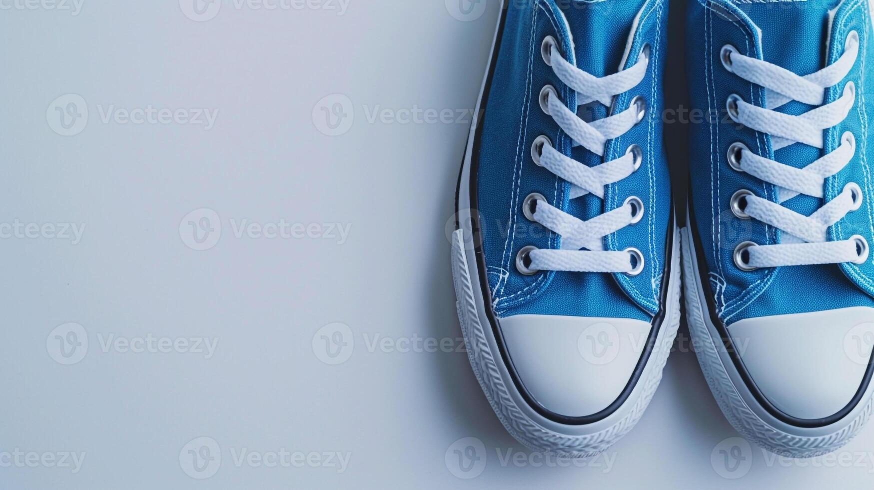 AI generated Blue canvas shoes isolated on flat white background with copy space for advertisement. Generative AI photo