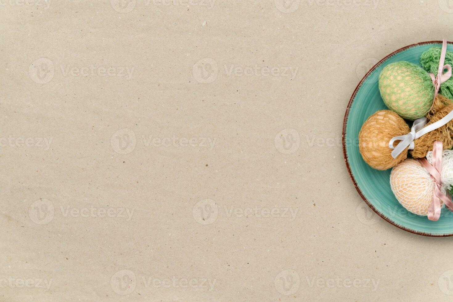 Easter eggs on a plate with craft paper background photo