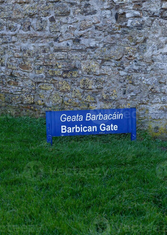 Barbican Gate sign on the green lawn photo