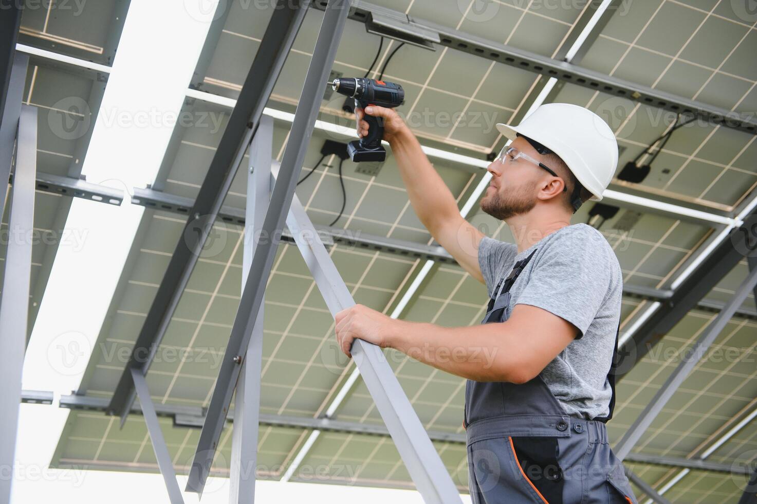 Worker installing solar panels outdoors photo