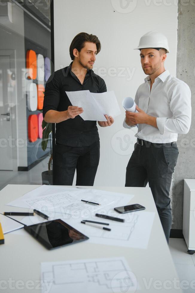 Architect concept, Architects working with blueprints in the office photo