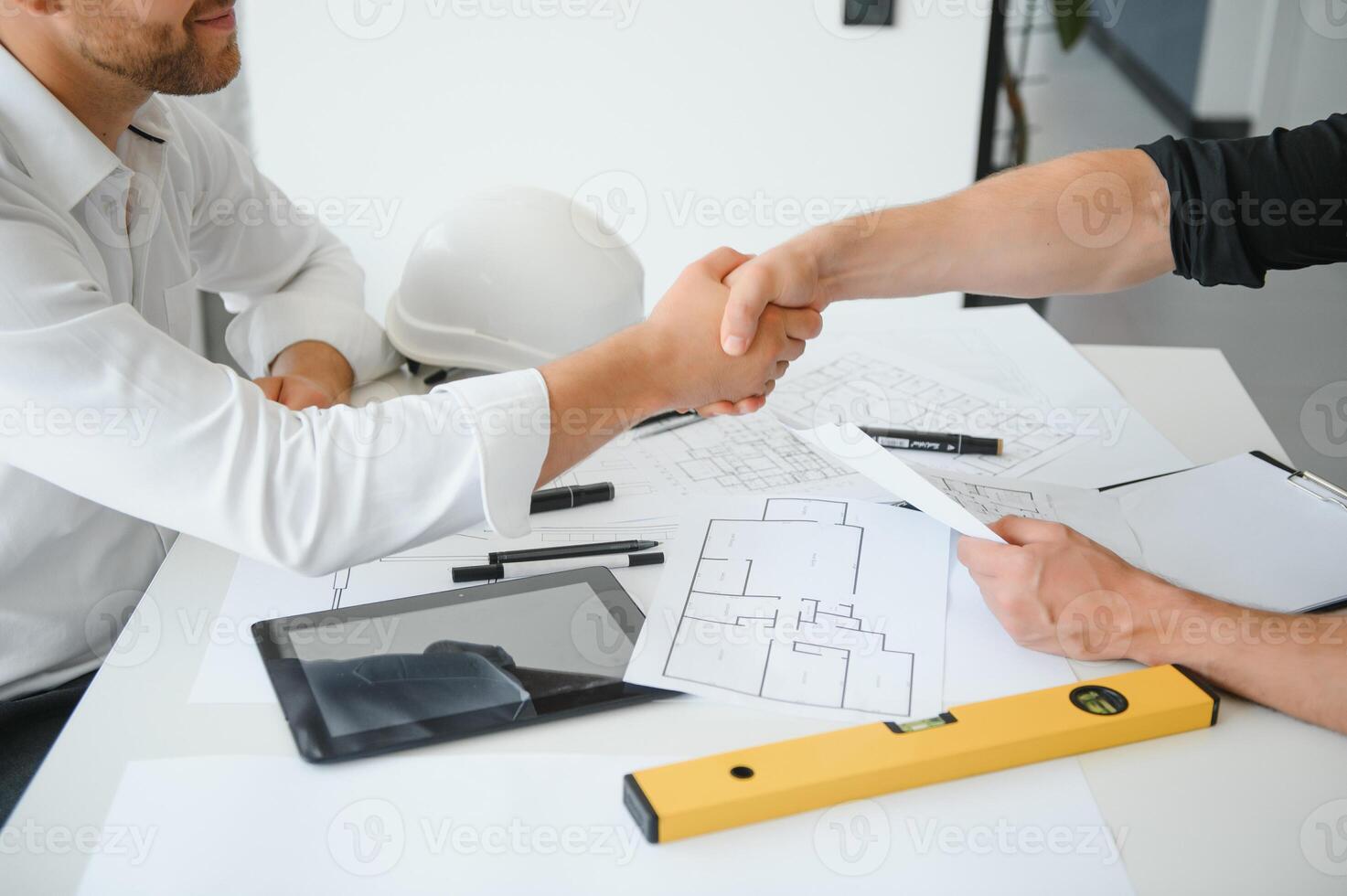 Engineer or architect teamwork working on construction project with building model and blueprint in office. Construction concept. photo