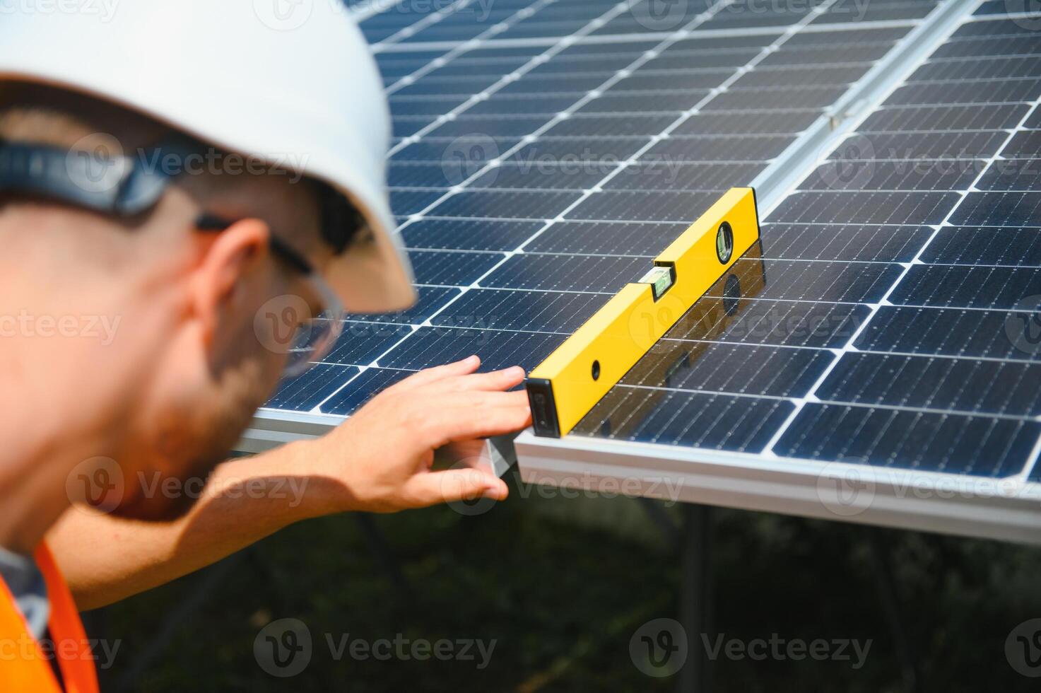 Worker installing solar panels outdoors photo