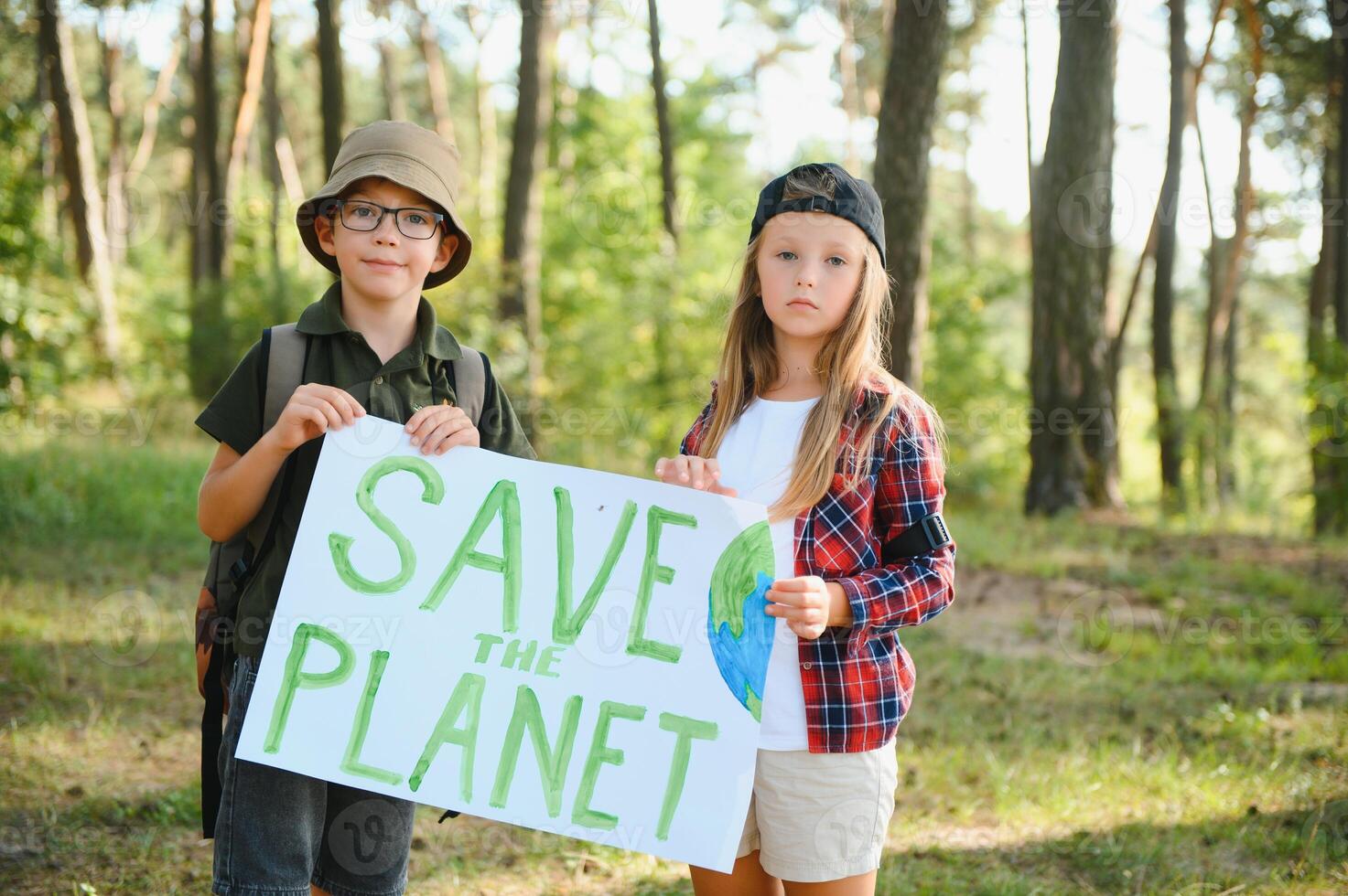 Children are holding a poster Save the planet. photo