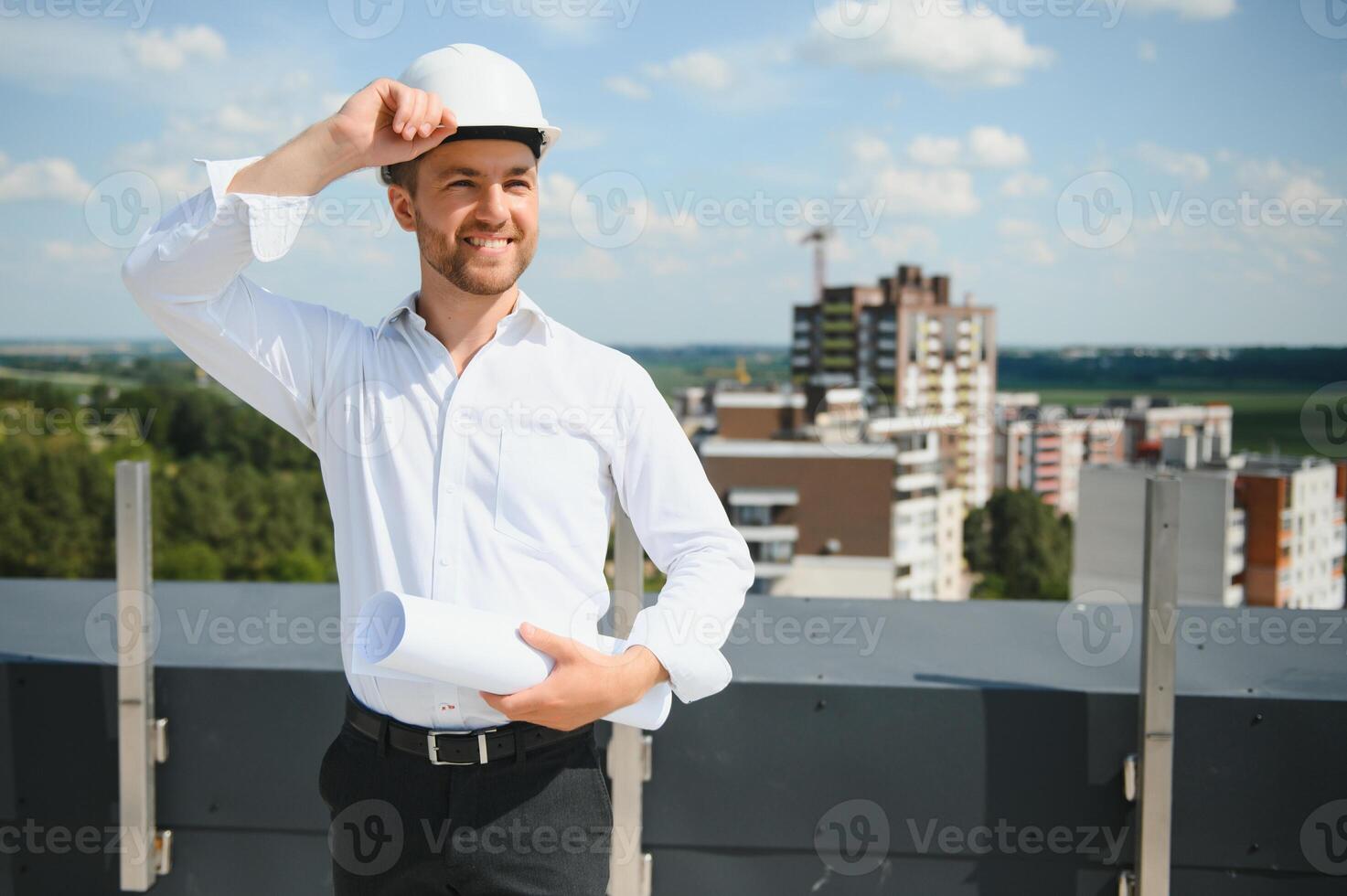 Close up engineers working on a building site holding a blueprints.Engineering and architecture concept photo