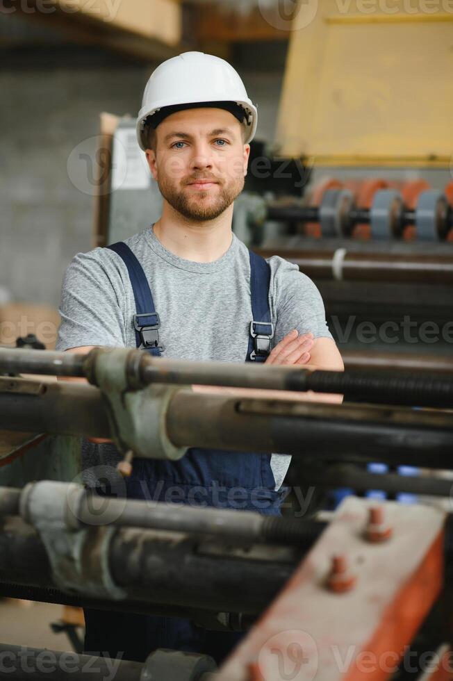 worker in factory on the machine photo