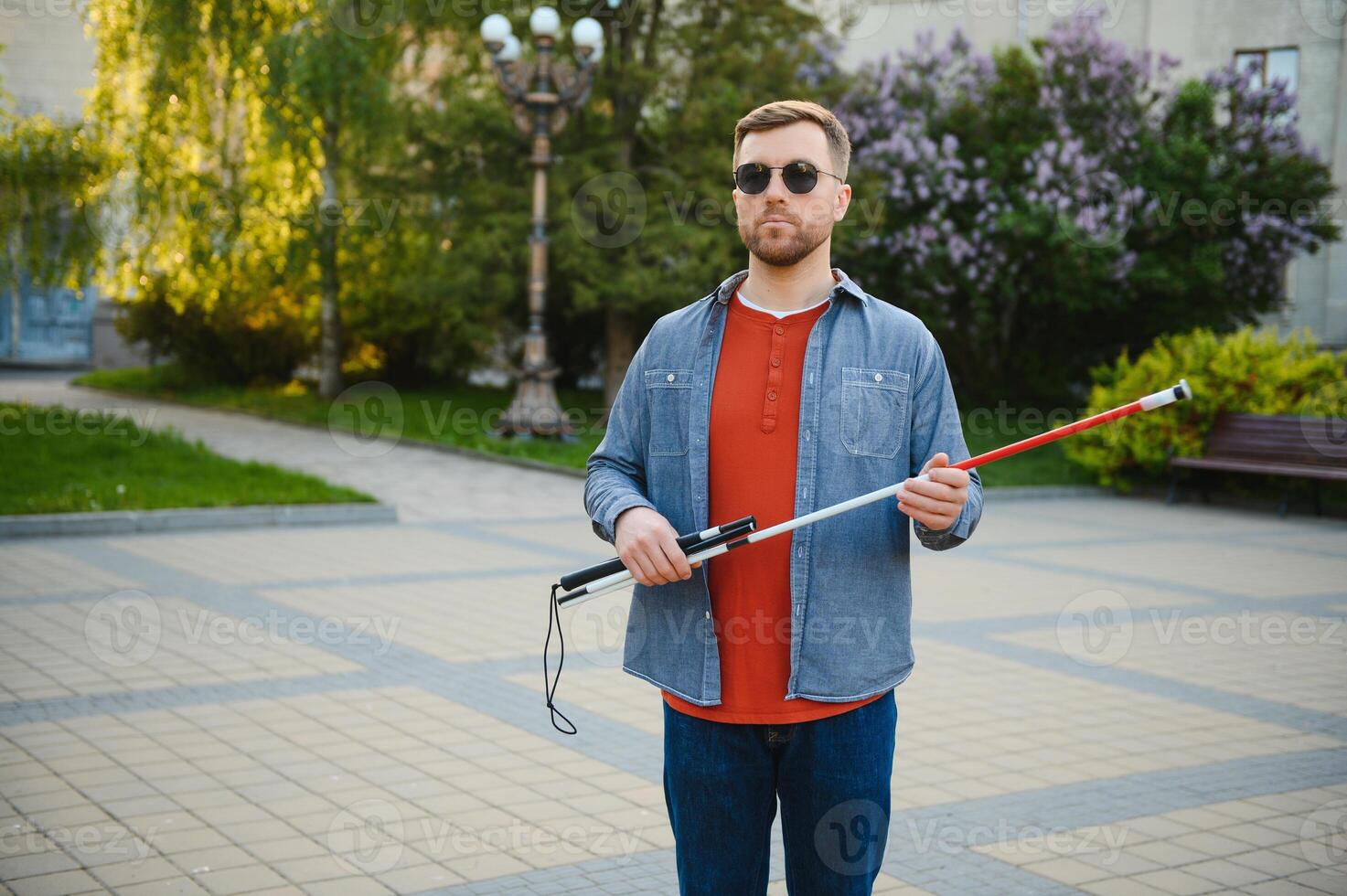 Blind man. People with disability, handicapped person and everyday life. Visually impaired man with walking stick. photo