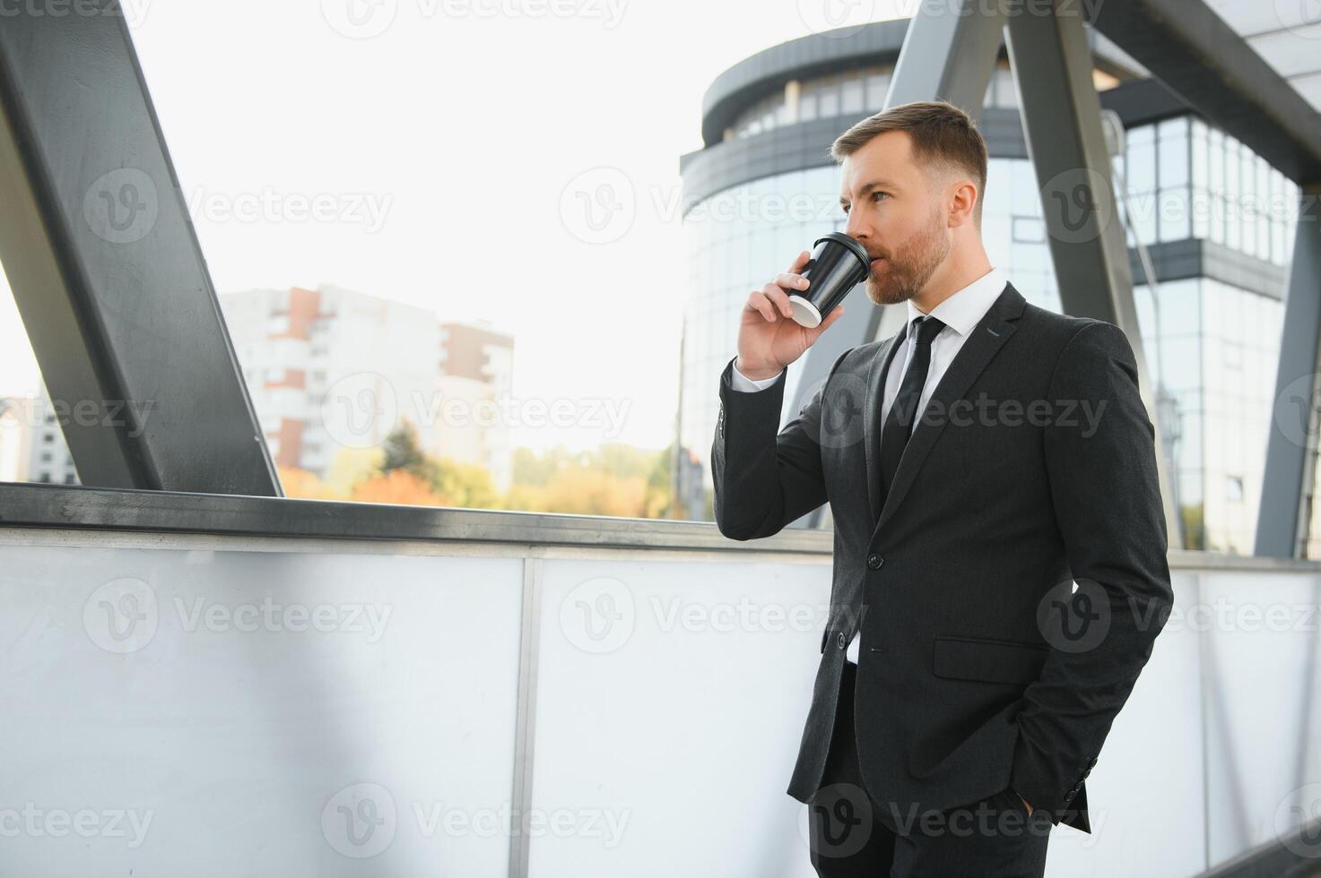 Takeaway coffee. Walk and enjoy fresh hot coffee. Waiting for someone in street. Man bearded hipster drink coffee paper cup. Businessman well groomed enjoy coffee break outdoors urban background photo