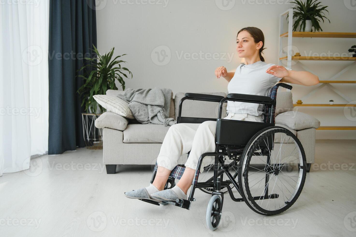 Brunette woman working out on wheelchair at home photo