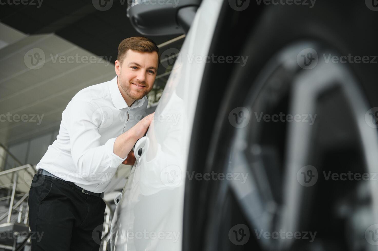 Man buying a car at a showroom photo