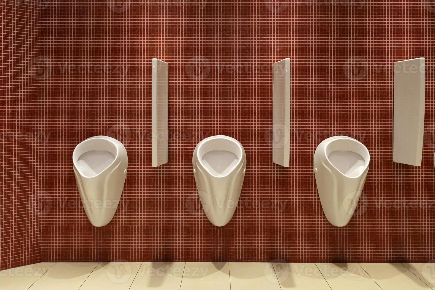 Urinals in a men's restroom photo