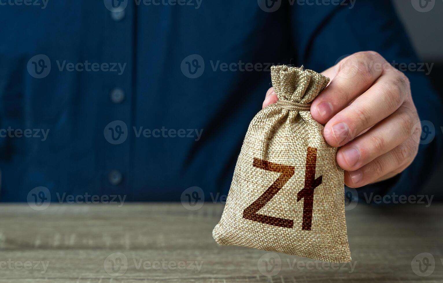 A man holds polish zloty money bag. Deposits and savings. Banks and finance. Investments, fundraising. Funding and grants. Loans, mortgage. Economics and currency exchange, stock market. photo