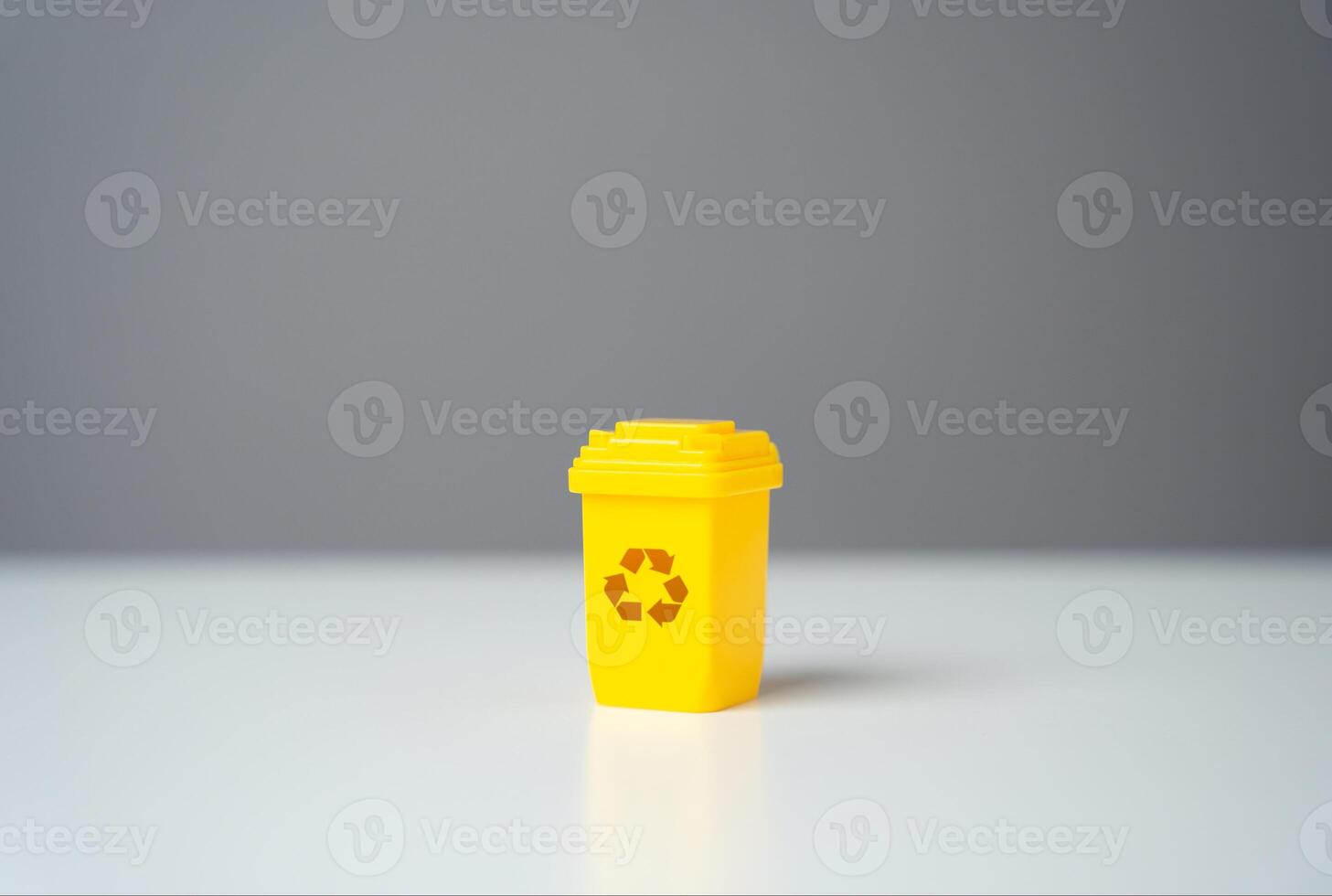 Yellow recycling bin. Circular economy. Selling recycled material or getting grants for green projects. Conserve natural resources, reduce waste, create jobs in recycling industry. photo