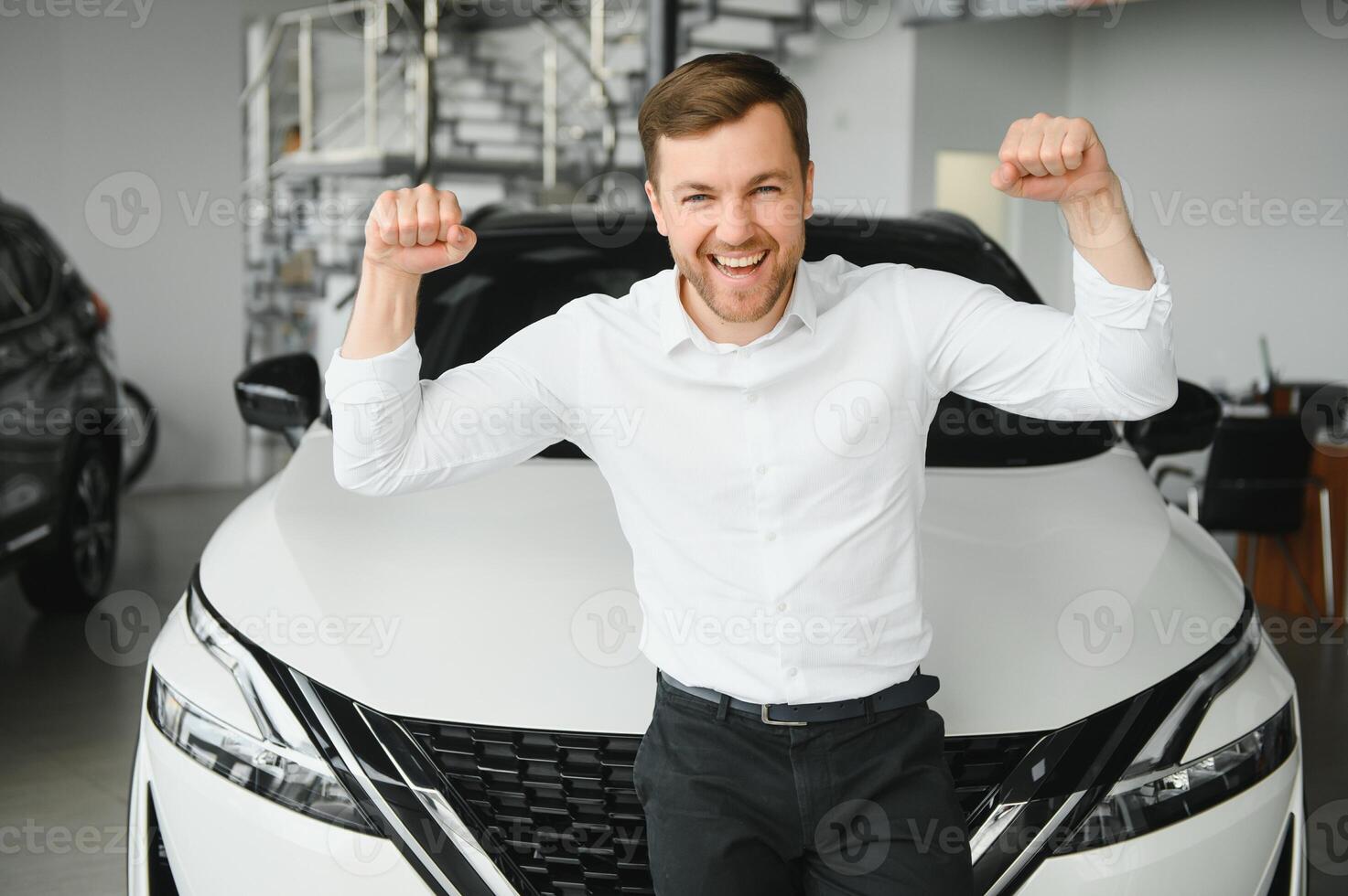 man in a car dealership buys a car photo