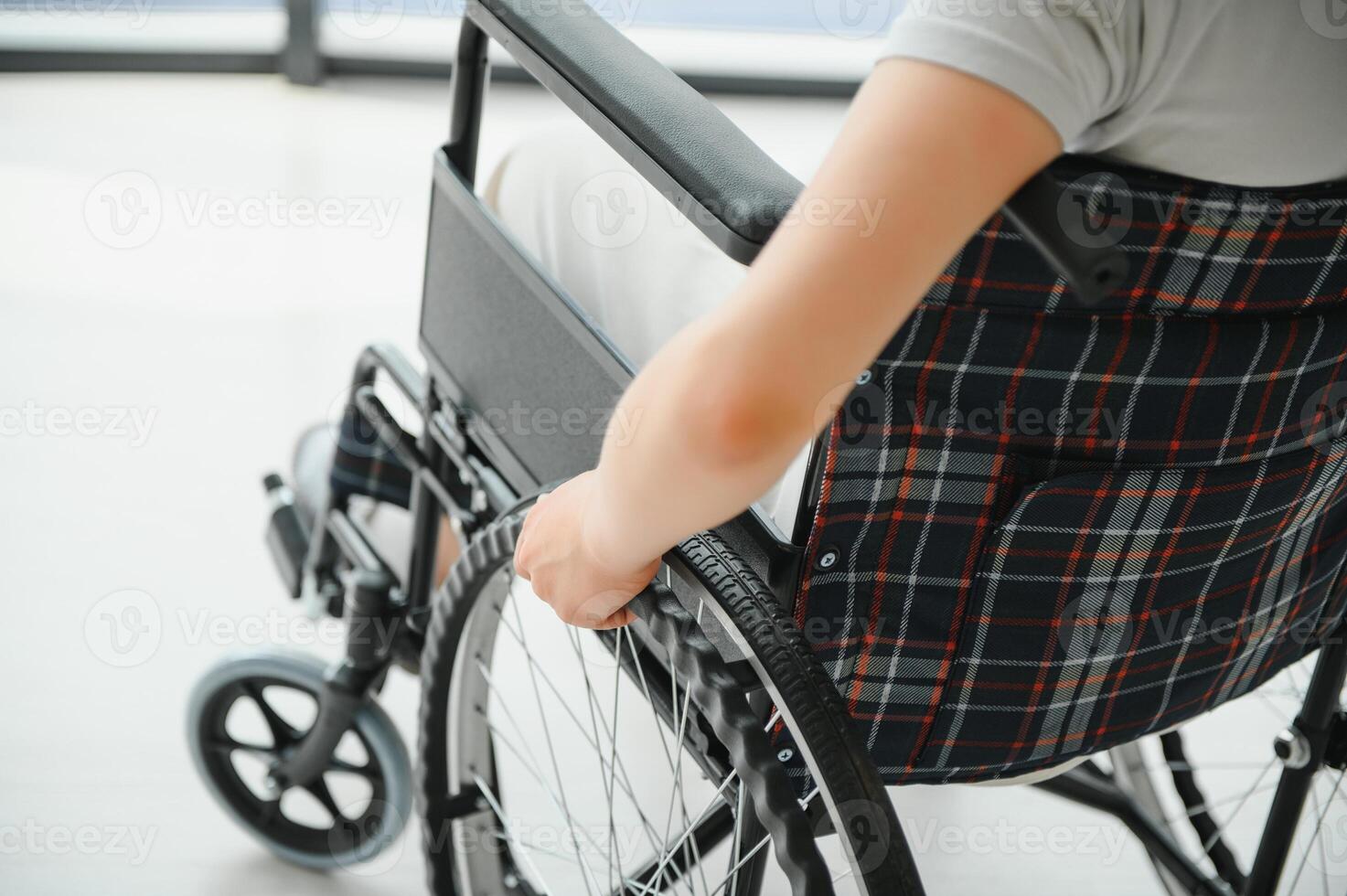 Young woman sitting in a wheelchair photo