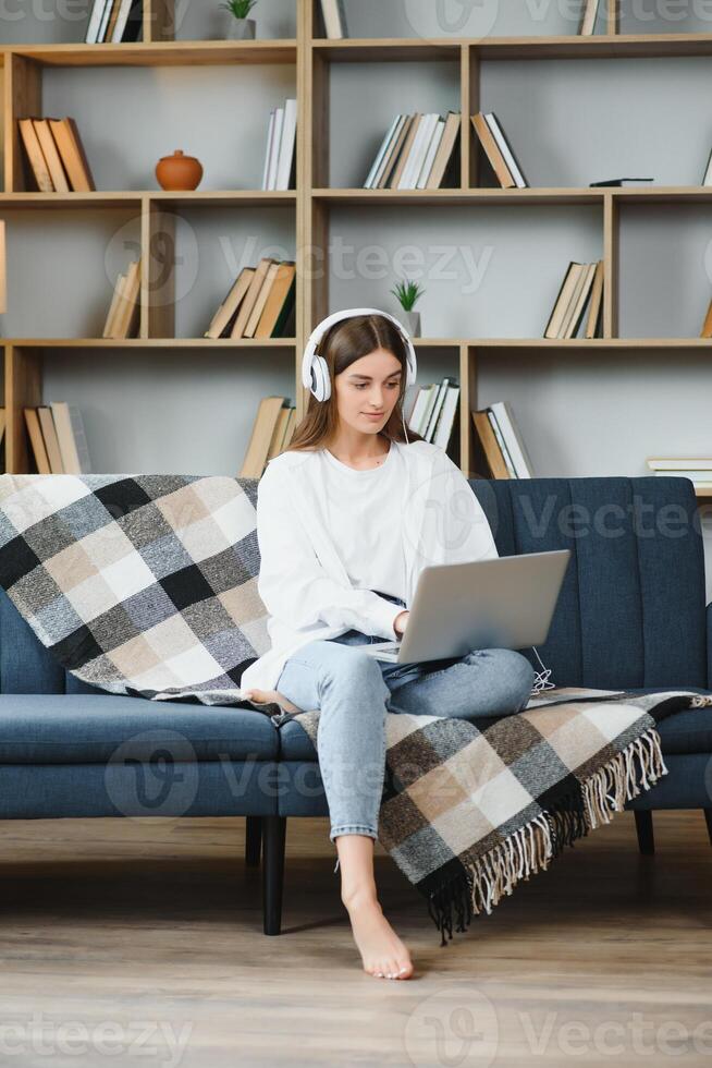 Full length portrait of cheerful charming person sit hold netbook browsing have good mood working home indoors photo
