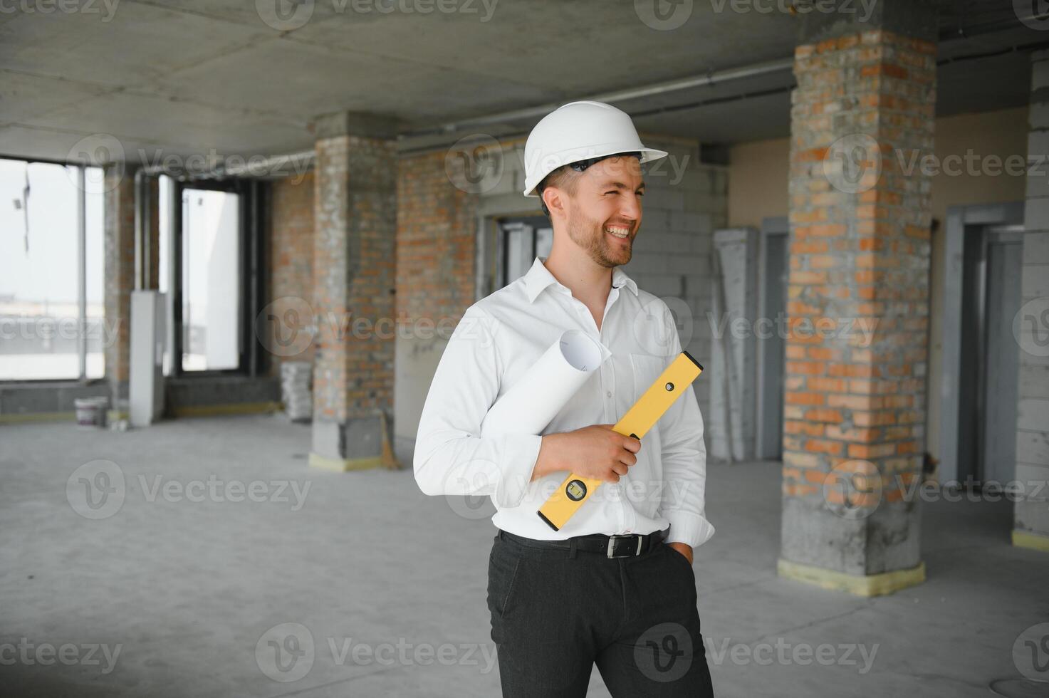 Close up engineers working on a building site holding a blueprints.Engineering and architecture concept photo