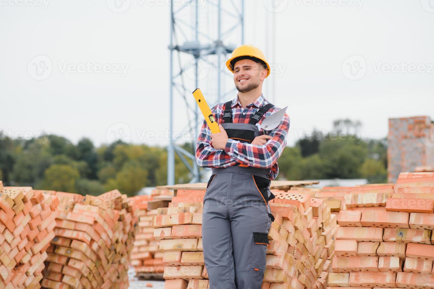 construction mason worker bricklayer installing red brick with trowel putty knife outdoors. photo