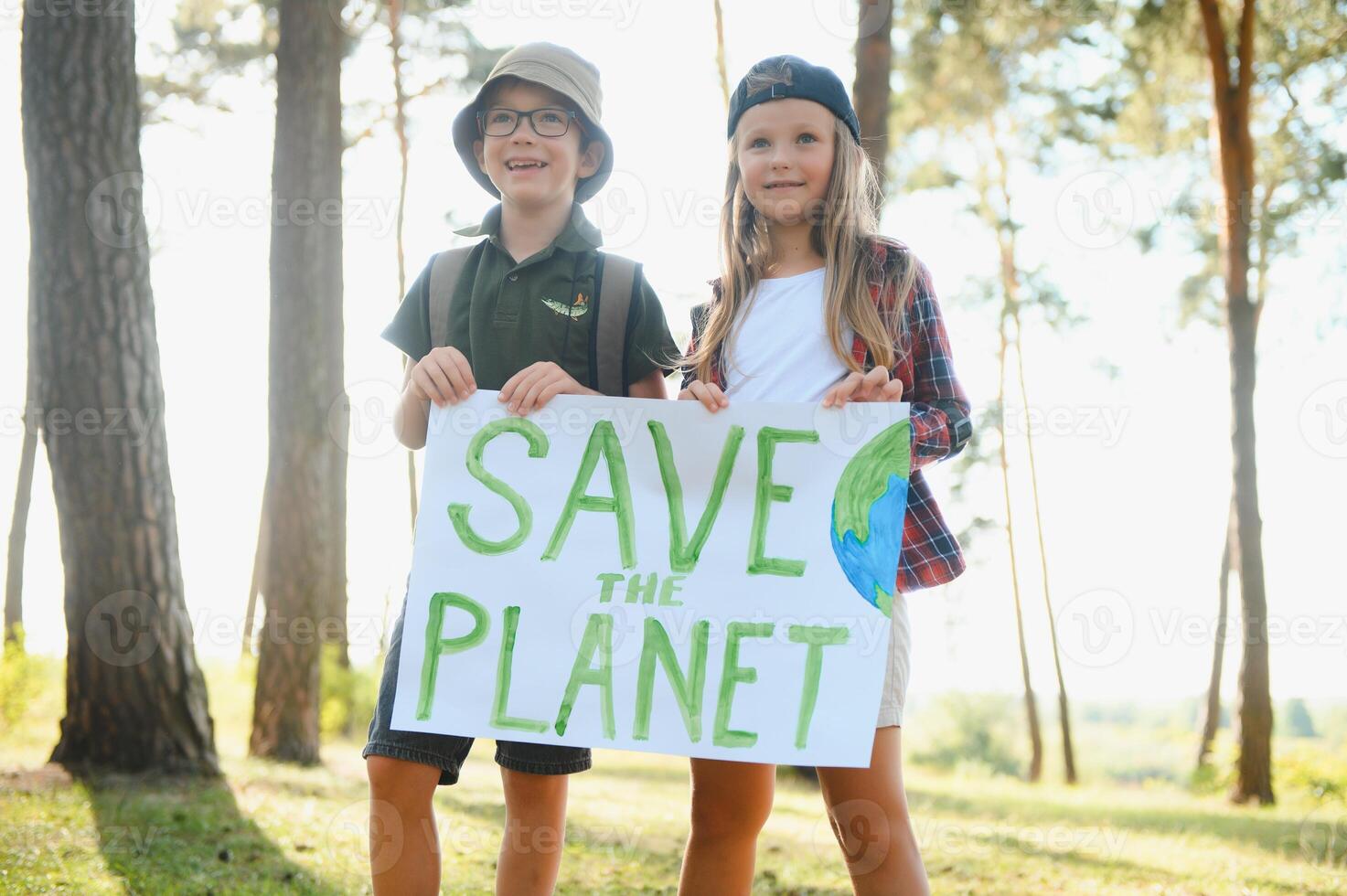 Children are holding a poster Save the planet. Earth Day. Let's save the planet from pollution. photo
