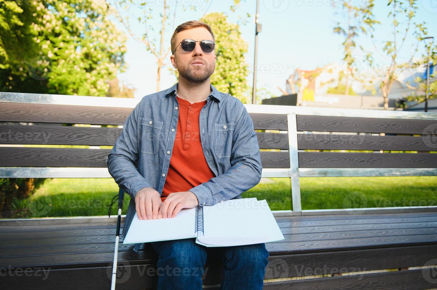 Blinded man reading by touching braille book photo