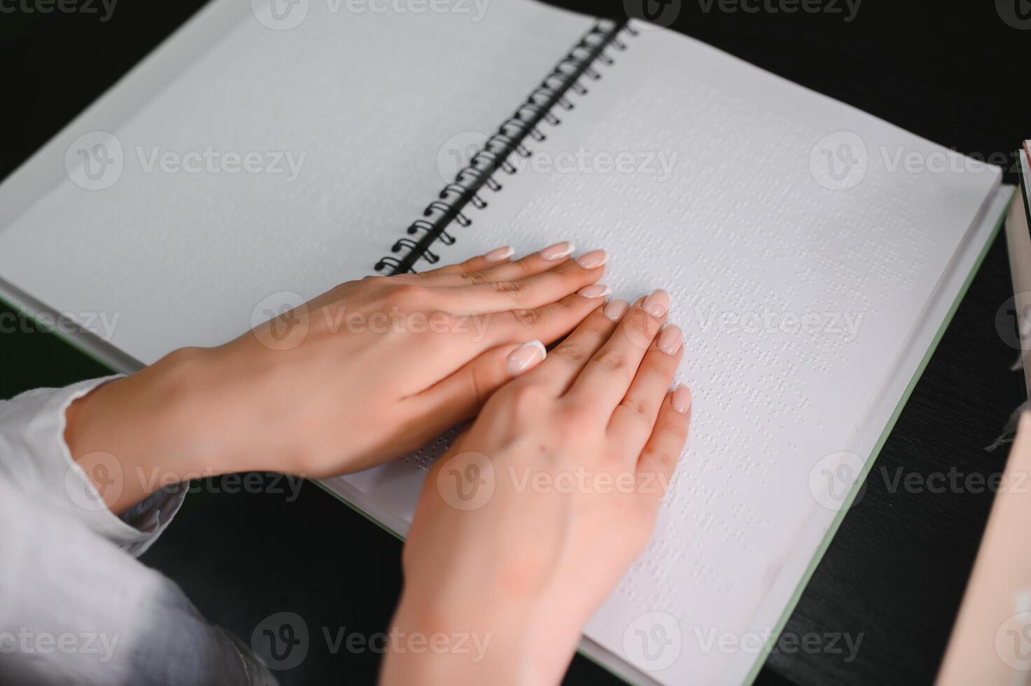 Blind woman read book written in Braille photo