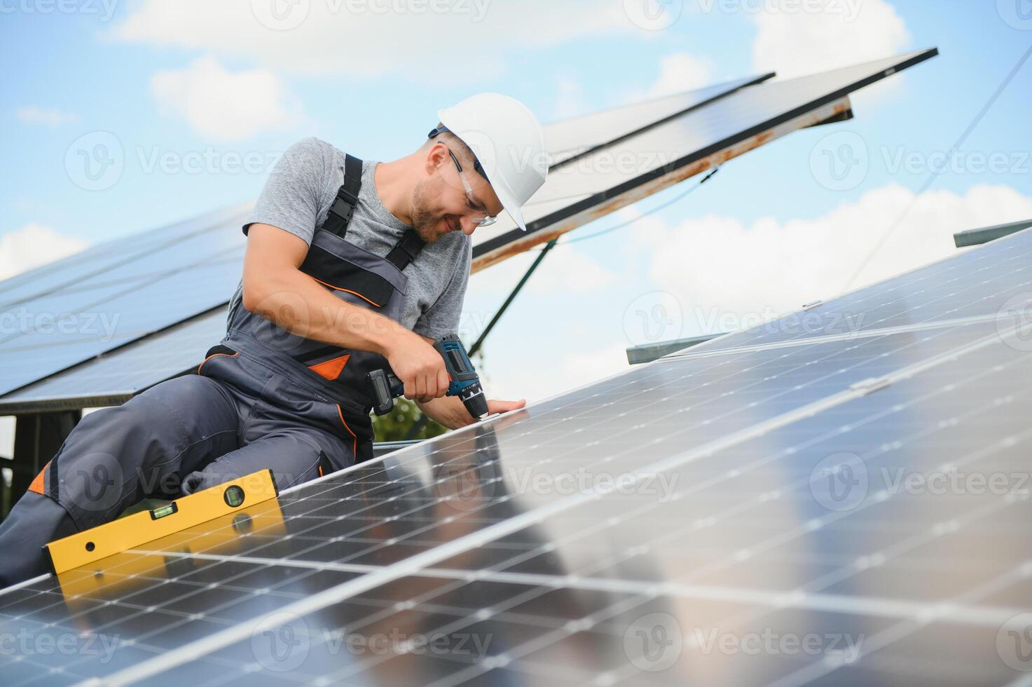 Worker installing solar panels outdoors photo