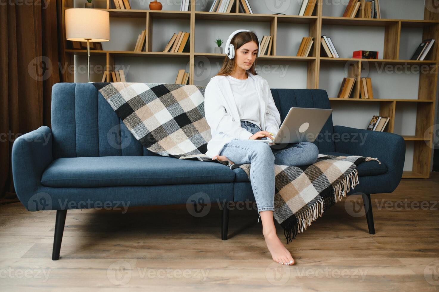 Full length portrait of cheerful charming person sit hold netbook browsing have good mood working home indoors photo