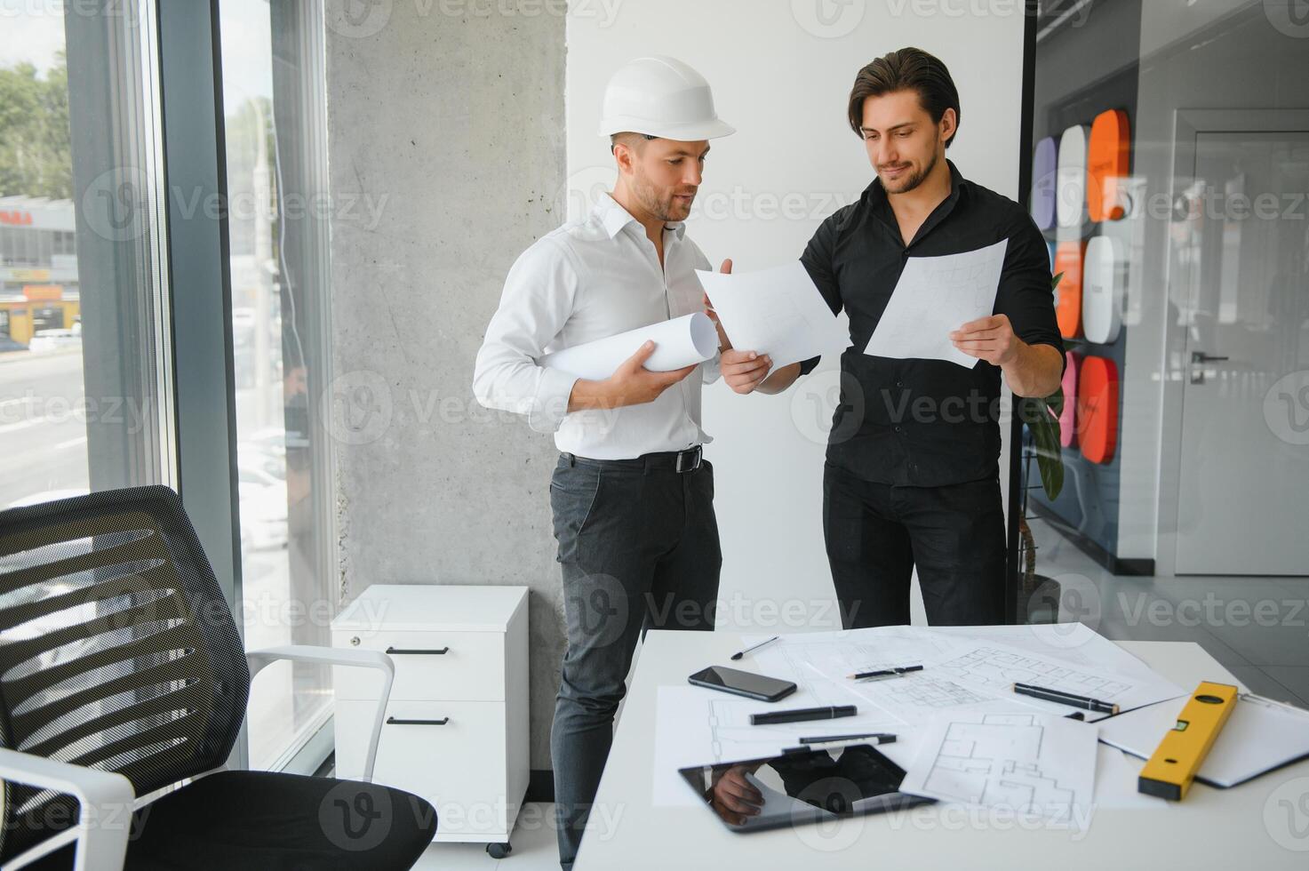 Engineer or architect teamwork working on construction project with building model and blueprint in office. Construction concept. photo