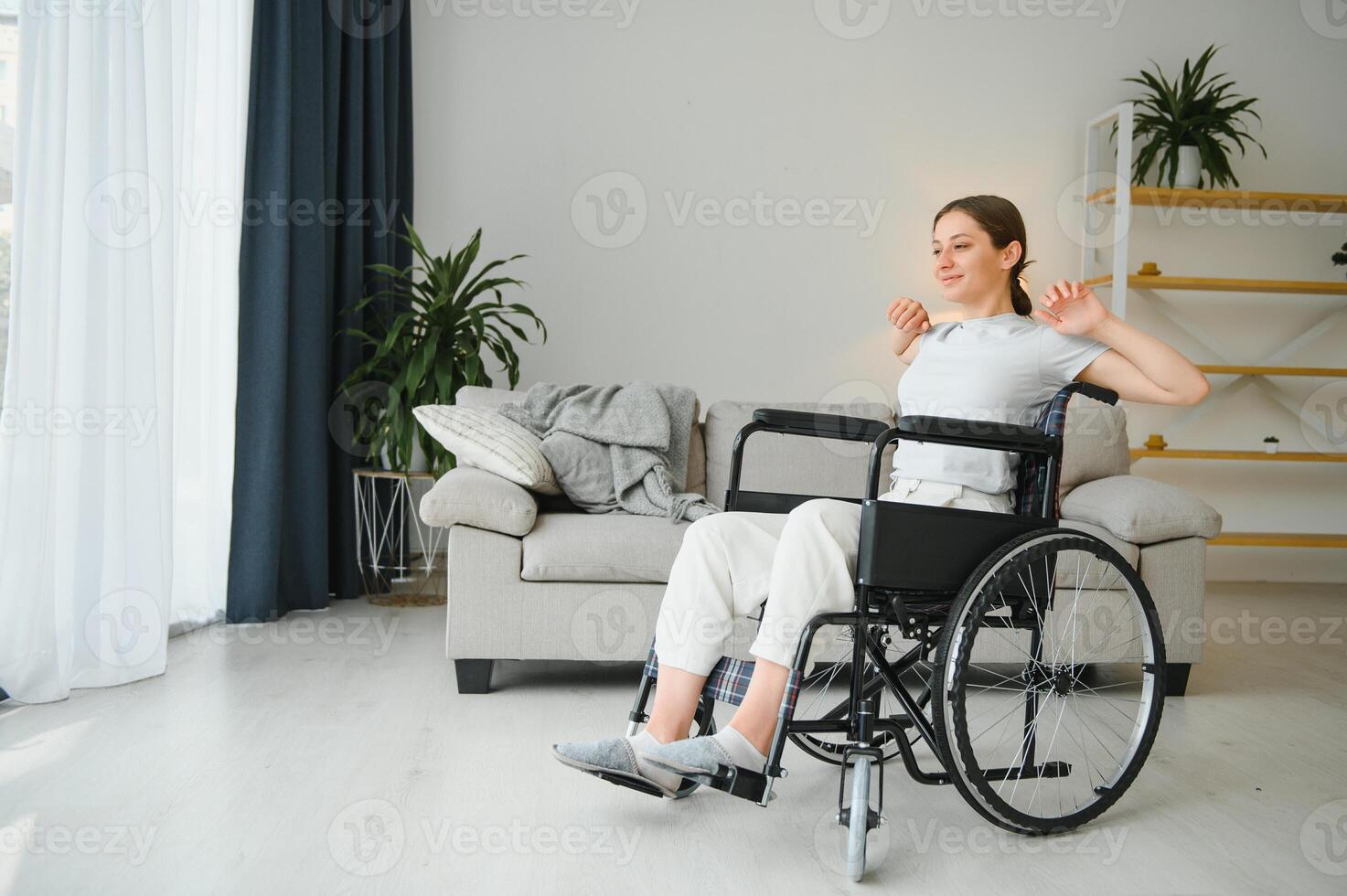 Brunette woman working out on wheelchair at home photo